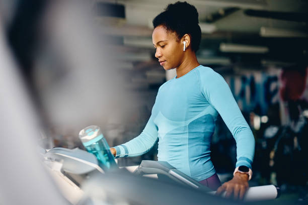 istock African American athlete using treadmill during her sports training in a gym. 1464034803