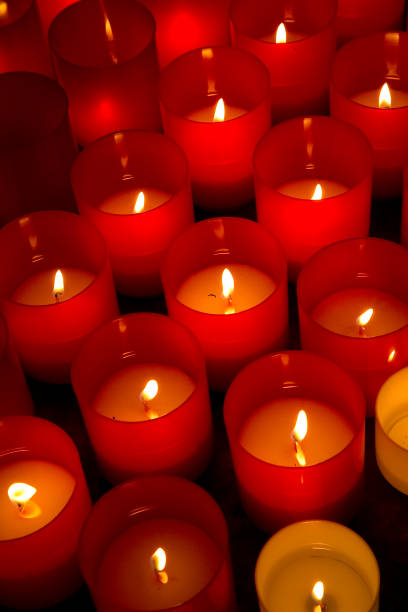 concept image with group of red votive candle - ispiration imagens e fotografias de stock