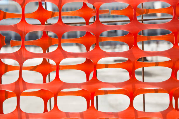 Plastic safety grid in construction site areas to delimit construction activities stock photo