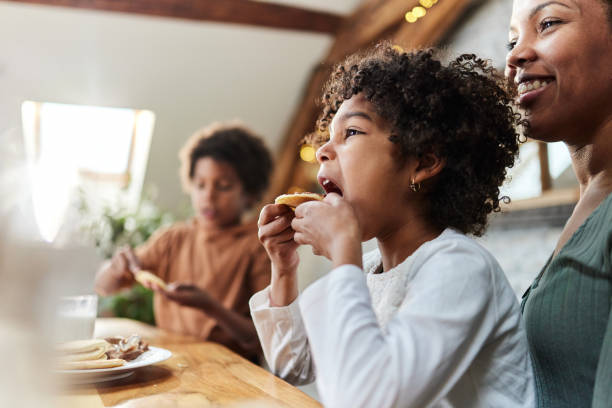 istock Cute black girl eating pancake at home. 1464045744