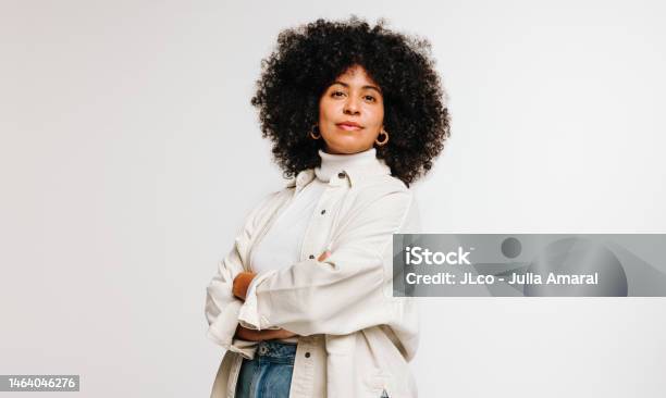 Selfconfident Woman With An Afro Hairstyle Standing In A Studio Stock Photo - Download Image Now