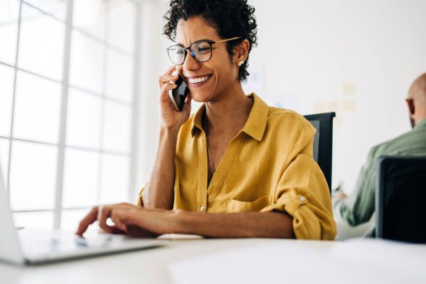 Female accountant talking on a phone call in an accounting firm stock photo