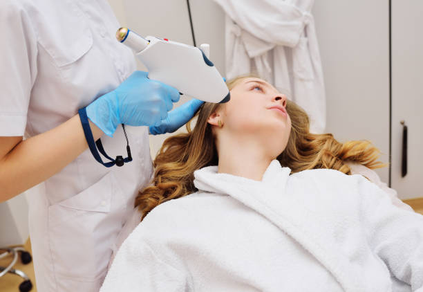 istock procedure of hardware skin rejuvenation using a cold stream of carbon dioxide CO2. A cosmetologist performs a skin rejuvenation procedure for an attractive woman 1464048190