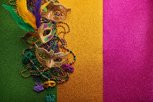 Mardi gras, Venetian or Carnivale mask on on a tricolor shining background