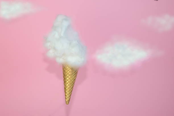 istock Ice-cream waffle cone with clouds isolated on a pink background 1464050608