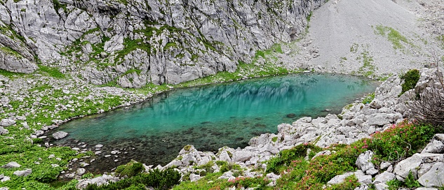 A panoramic shot of a Crystal clear pond surrounded by mountains in Berchtesgaden Bavaria Germany
