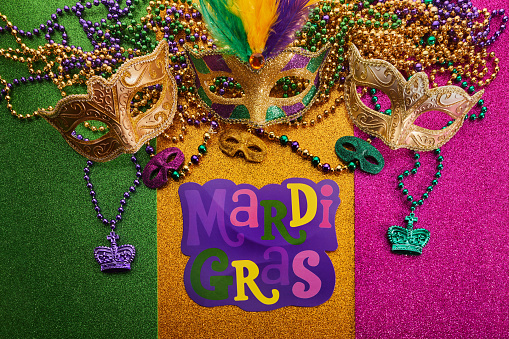 Mardi gras, Venetian or Carnivale mask on on a tricolor shining background