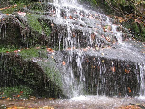 istock View of the river flowing down the stone cascade on an autumn day 1464054511