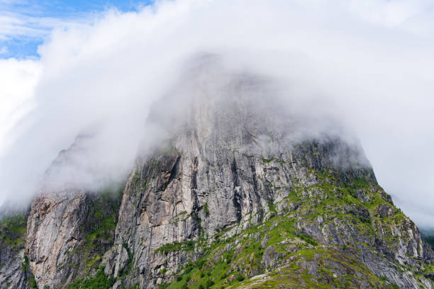 istock Mountain peak on Lofoten island covered in mist on a sunny day 1464057992