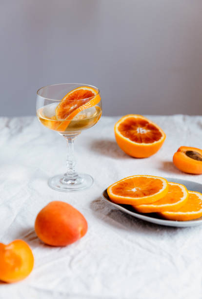 istock Cocktail with red orange and sliced oranges on a white tablecloth 1464062958
