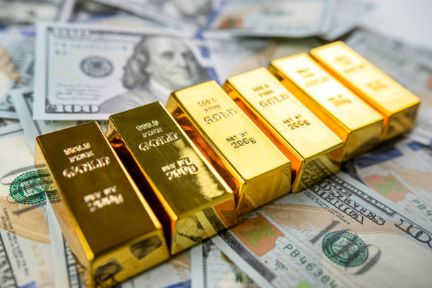 istock closeup gold bar lying on 100 dollar bills 1464063046