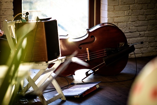 A selective focus shot of a stage with a cello
