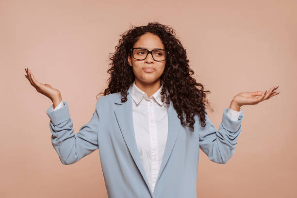 istock Young confused woman shrugging shoulders with doubt emotion 1464069601