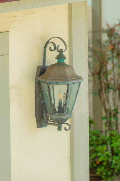 istock Vertical shot of an old and rustic lamp on the wall 1464070229