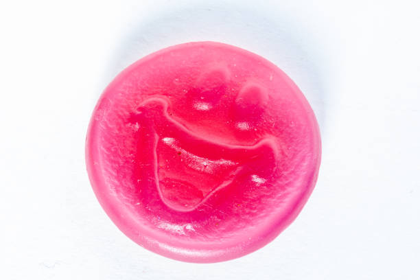 A colorful smiley gummy candy isolated on a white background