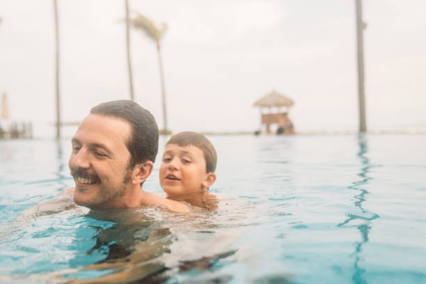 istock Father with son in the pool 1464070818