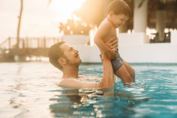 istock Father with son in the pool 1464071078