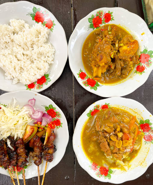 istock Goat satay and Goat curry with rice and vegetables on plate in the table 1464071152