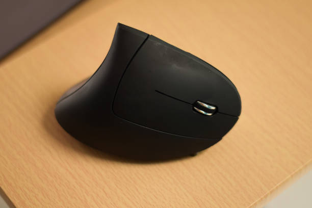istock High angle shot of a black mouse on a wooden table 1464072539