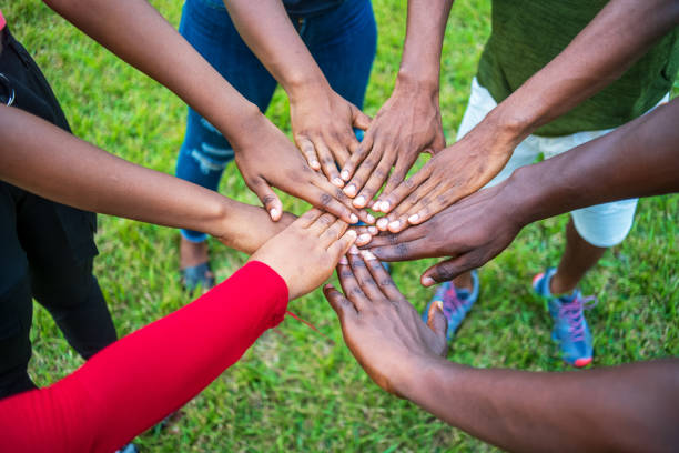 istock Teamwork concept with different skin color touching hands standing outside 1464075309