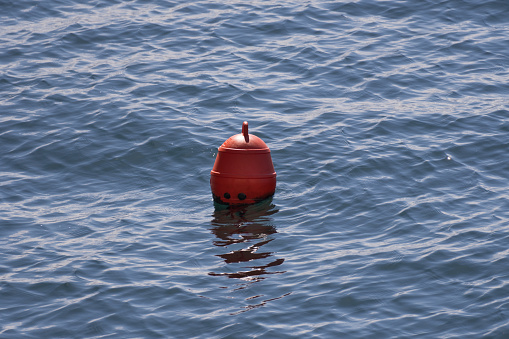 Small Red Buoy floating in the sea