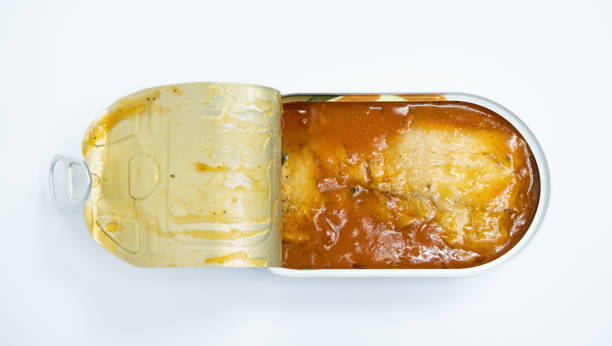 istock Fish preserves in tomato sauce - an open can on a white background 1464076935