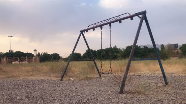 Old rusty swing in an abandoned area
