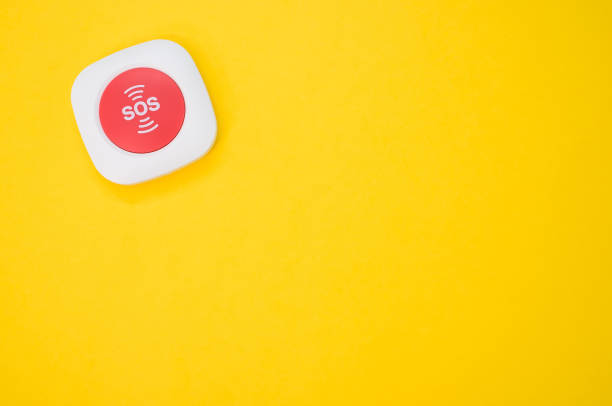 istock Top view of an SOS button on a yellow surface 1464082091