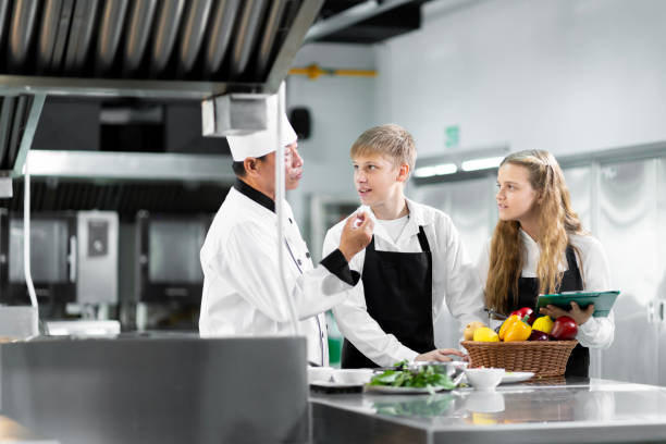 istock Students are learning to cook in a culinary institute with a standard kitchen and complete equipment. And have a professional chef as a trainer. 1464082233