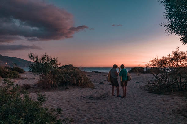 istock Middle-aged women on a tropical sandy beach at sunset 1464082626