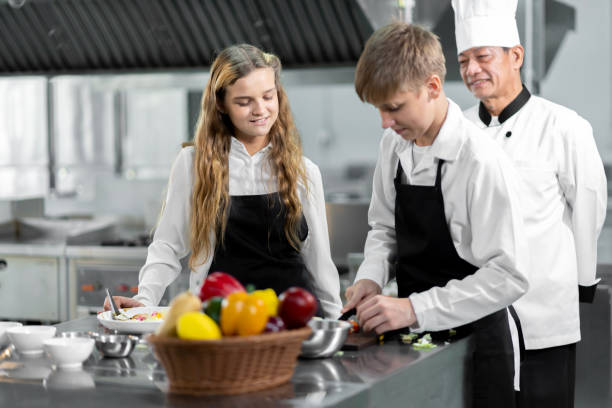 istock Students are learning to cook in a culinary institute with a standard kitchen and complete equipment. And have a professional chef as a trainer. 1464082916
