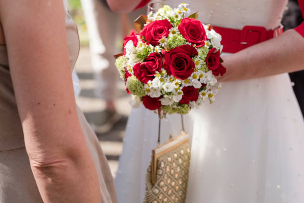 istock Bride holding her beautiful wedding bouquet while talking to the wedding ceremony 1464082950