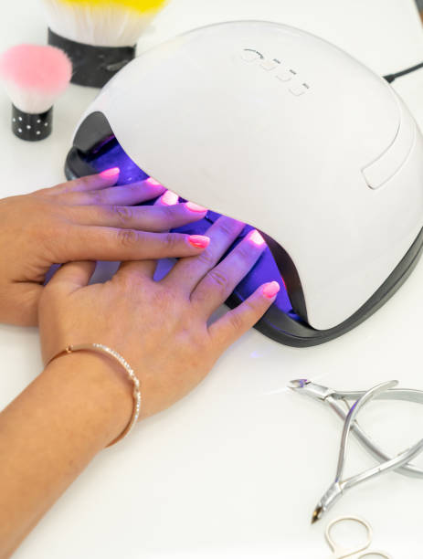 istock Female drying gel polish in a lamp 1464083054