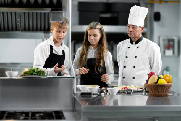 istock Students are learning to cook in a culinary institute with a standard kitchen and complete equipment. And have a professional chef as a trainer. 1464083361
