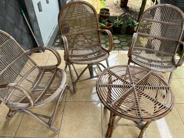istock Table and chair made from rattan outside a house. 1464087941