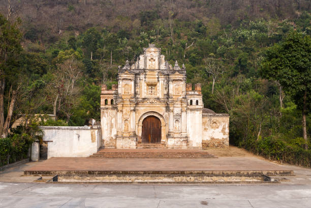 istock Baroque architecture in Catholic church, exterior facade with mountainous background. 1464088548
