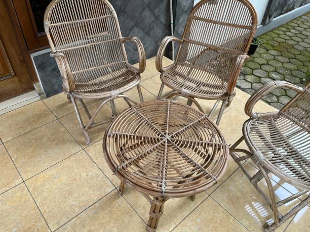istock Table and chair made from rattan outside a house. 1464088576
