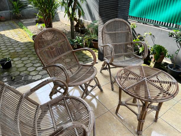 istock Table and chair made from rattan outside a house. 1464088632
