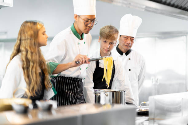 istock Students are learning to cook in a culinary institute with a standard kitchen and complete equipment. And have a professional chef as a trainer. 1464089863