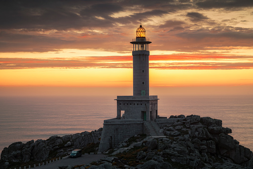 A beautiful scene of Punta Nariga lighthouse at sunset, Galicia, Spain