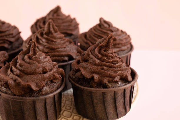 istock Close-up of chocolate cupcakes on pink background. 1464091194