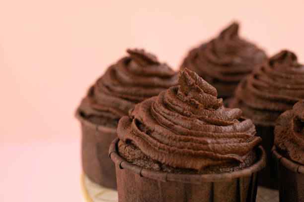 istock Close-up of chocolate cupcakes on pink background. 1464091270