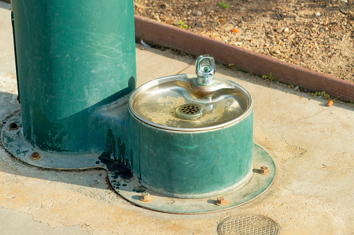 A closeup shot of an old dog drinking fountain in a park