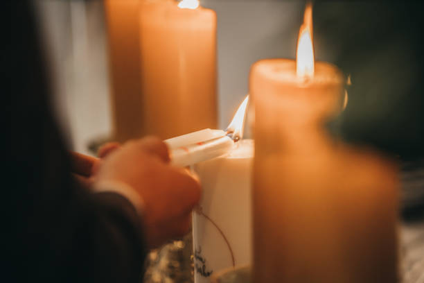 istock Closeup shot of  couple's hands burning the candles 1464094286