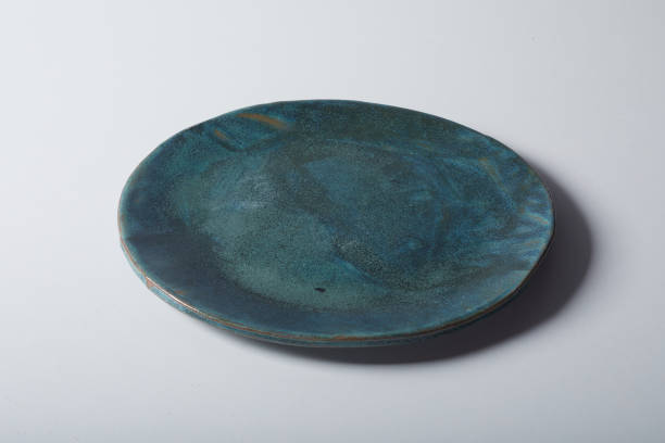 istock Closeup shot of a handmade blue ceramic plate on a white surface 1464095262