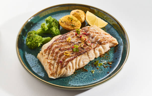 istock Gourmet dish with juicy baked cod fish fillet and vegetables 1464095273