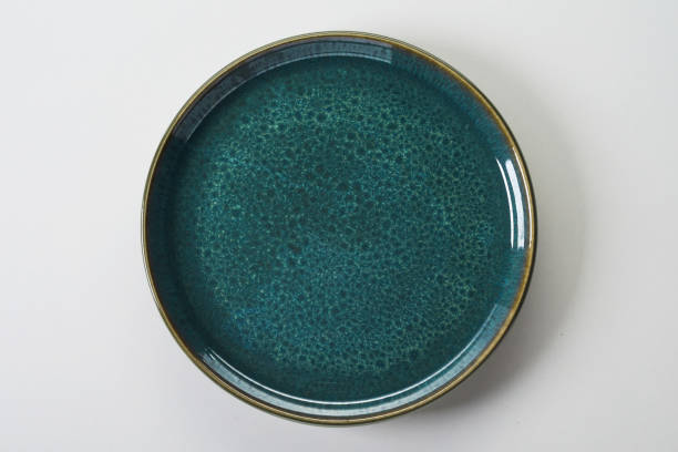 istock Top view of a blue ceramic flat plate on a white background 1464095295