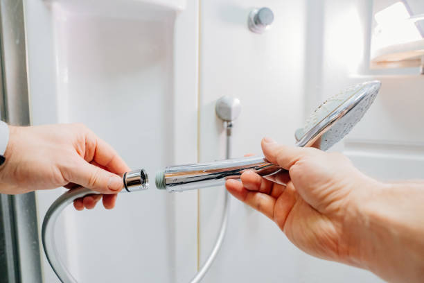 istock men's hands screw the shower head onto a new hose. 1464095597