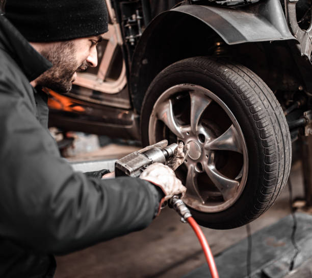 istock mechanic changing the tire 1464095706