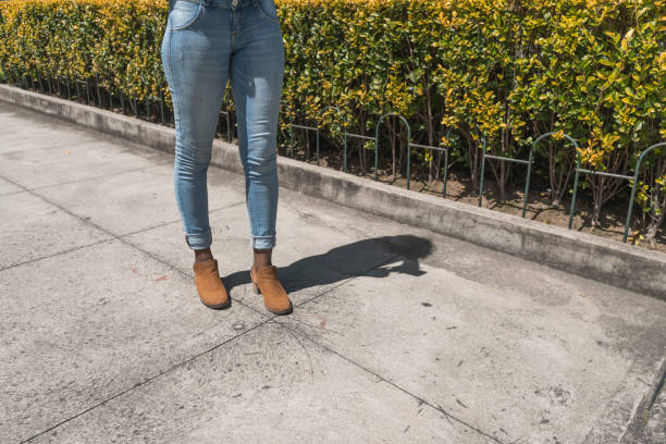 istock Legs with jeans in a park 1464099664